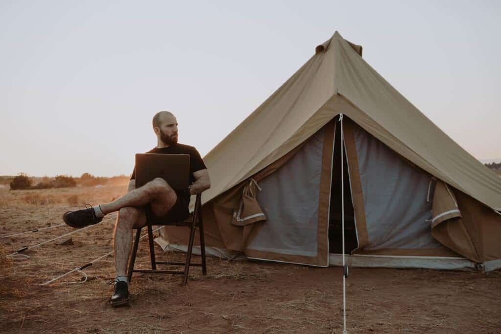 A man working in front of tent