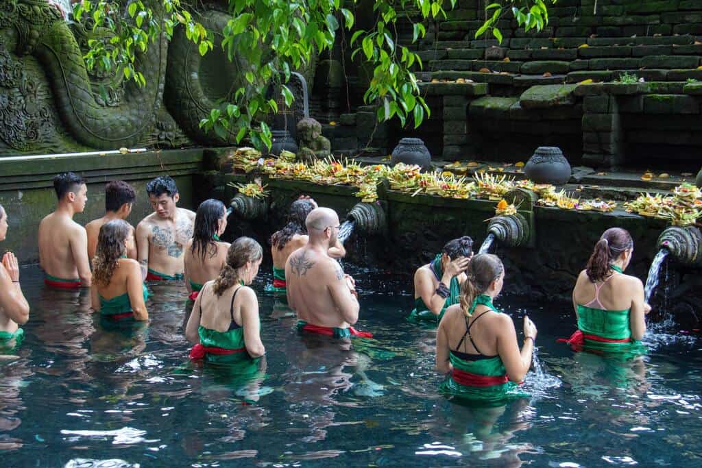tourist are lining in the pura tirtha empul's pool to get blessings