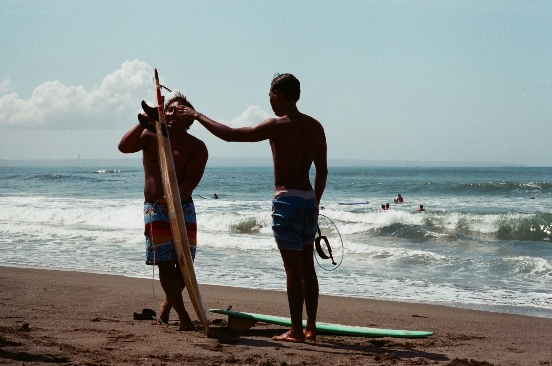 two men with a surfboard in Canggu